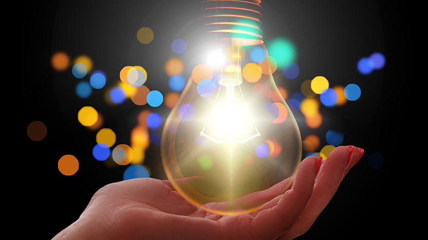 A hand holding a lamp.