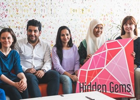 Hidden Gems participants sitting on the sofa together.