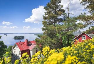 Summery view from Pispala with lake Pyhäjärvi and wooden houses.