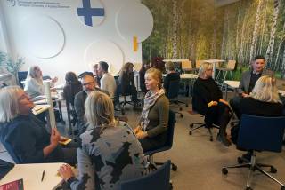 People sitting and discussing in a classroom. 