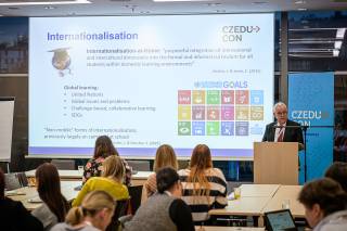 A man talking in front of an audience.