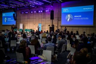 A presenter in front of an audience.