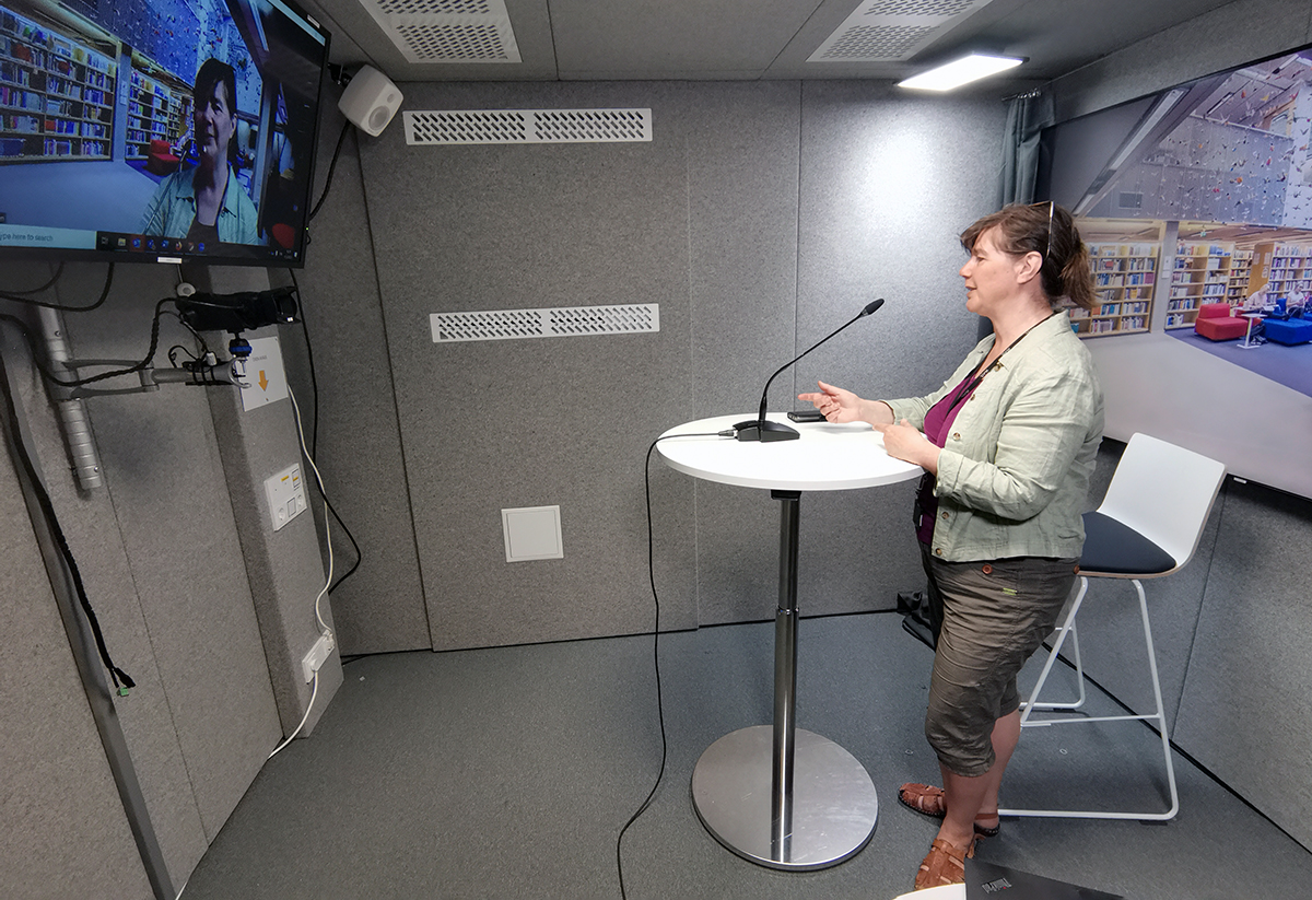 A woman recording a video shot in a studio.