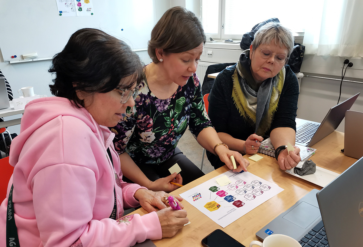 Three women studying together in a classroom.
