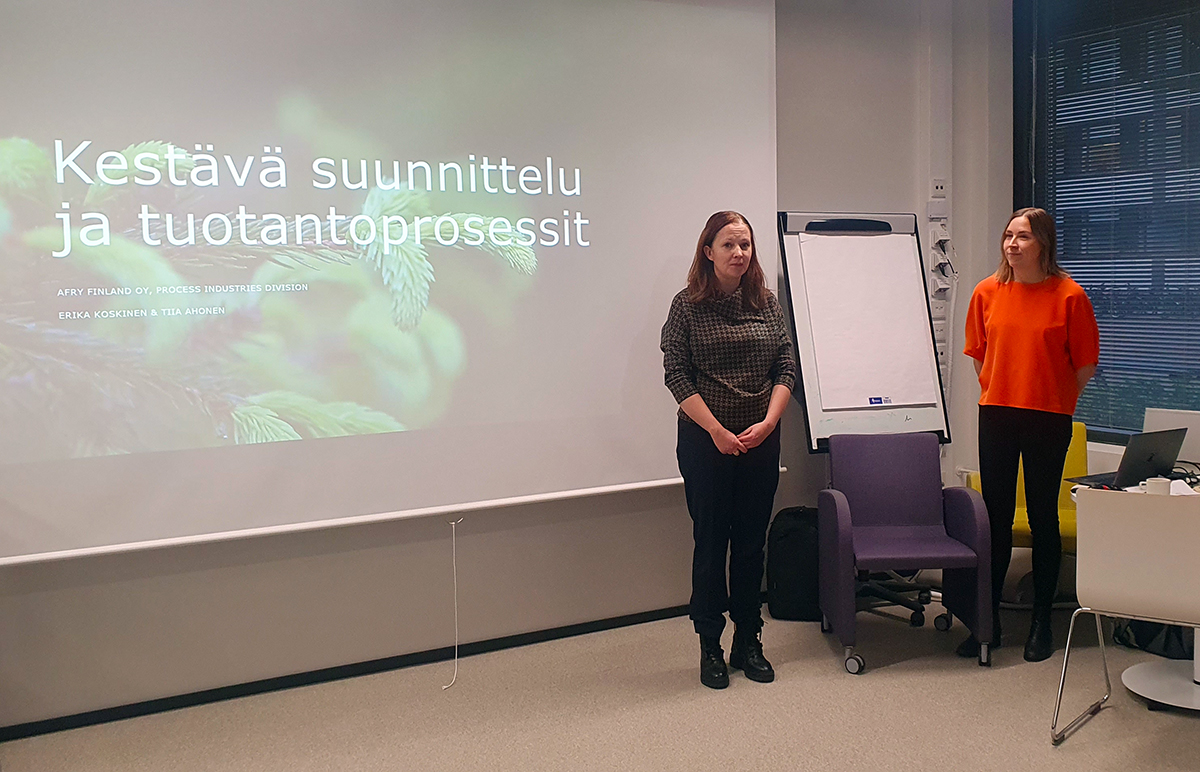 Kaksi naista pitää esitystä luokkahuoneessa.