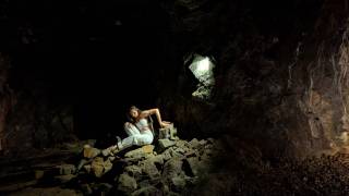 human body on a pile of rocks in a mining tunnel
