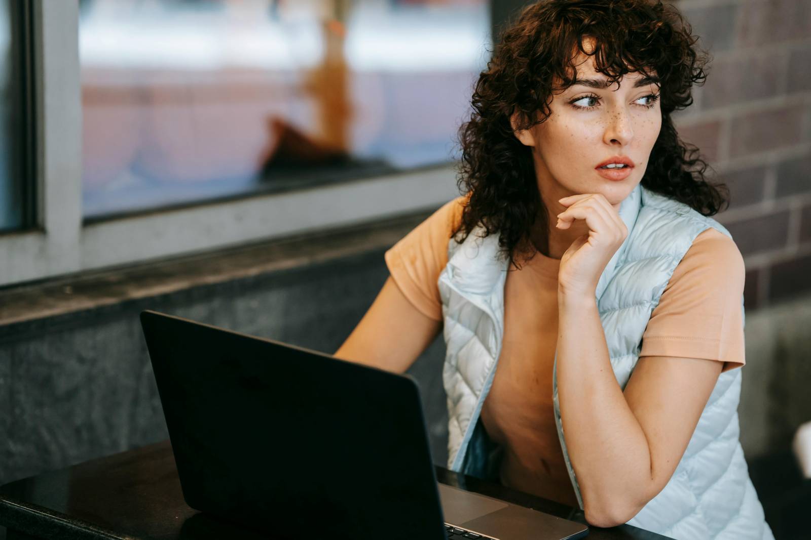 Person sitting thoughtfully in front of computer