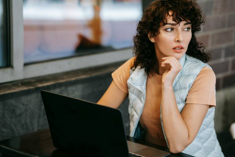 Person sitting thoughtfully in front of computer