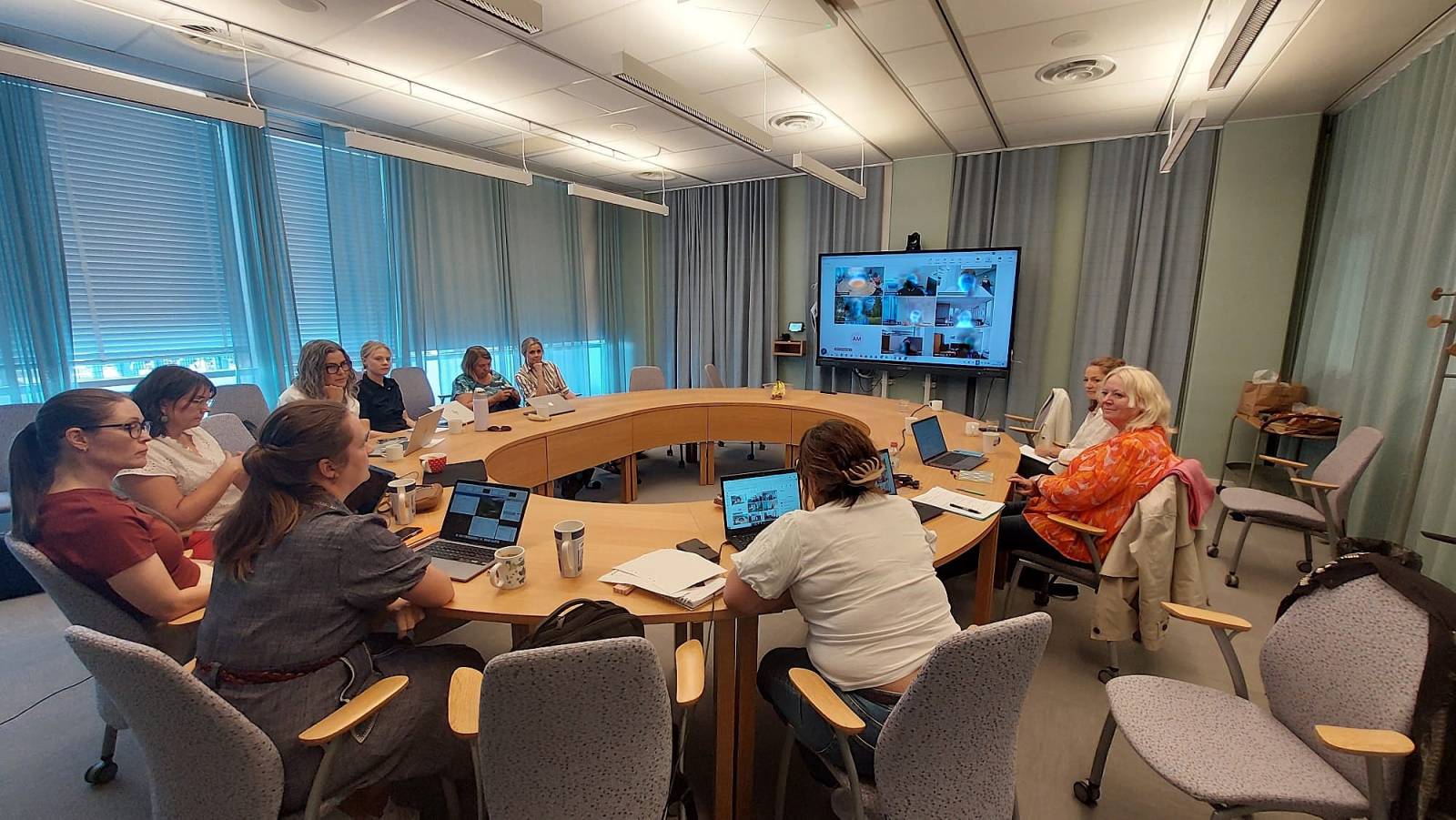 A picture of people gathered around a table.