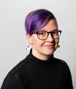 Upper body portrait of Usva Friman.