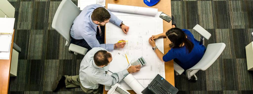 Three people working together at a table