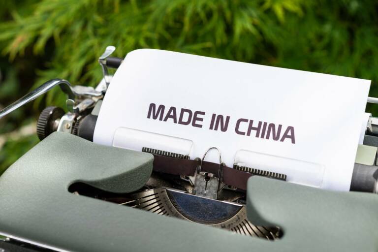 A typewriter with white paper with typed text: "Made in China".