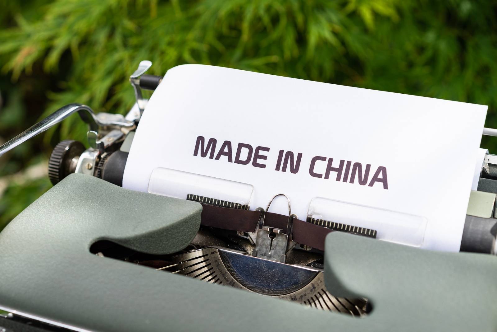 A typewriter with white paper saying Made in China.