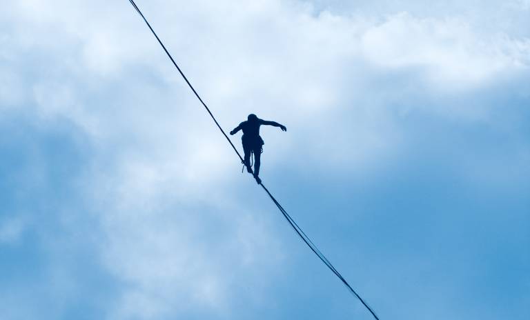 Human walking on trapeze