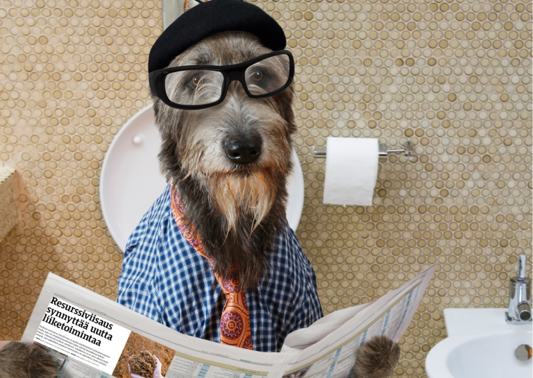 Humoristisessa kuvassa koira lukee wc-pöntöllä lehteä, jossa on PITS-hankkeen "Resurssiviisaus synnyttää uutta liiketoimintaa" -artikkeli.